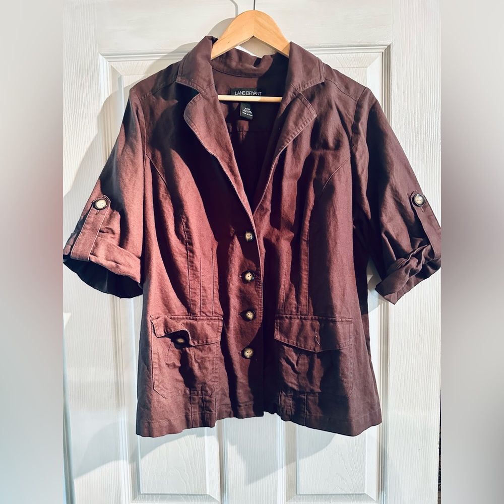 Cute shaped jacket like top. Short sleeve with button down front. Size 18/20